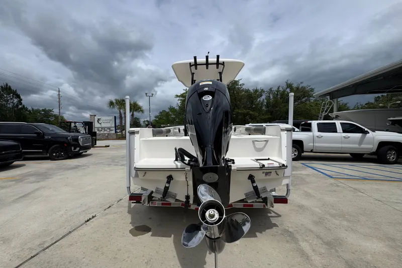 Slide: The Image of 2026 Sea Born LX21 Center Console boat with powerful outboard motor in a parking lot. - 12