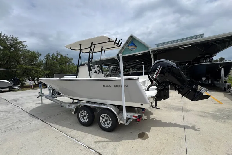 Slide: The Image of 2026 Sea Born LX21 Center Console boat on trailer, parked outdoors. - 14