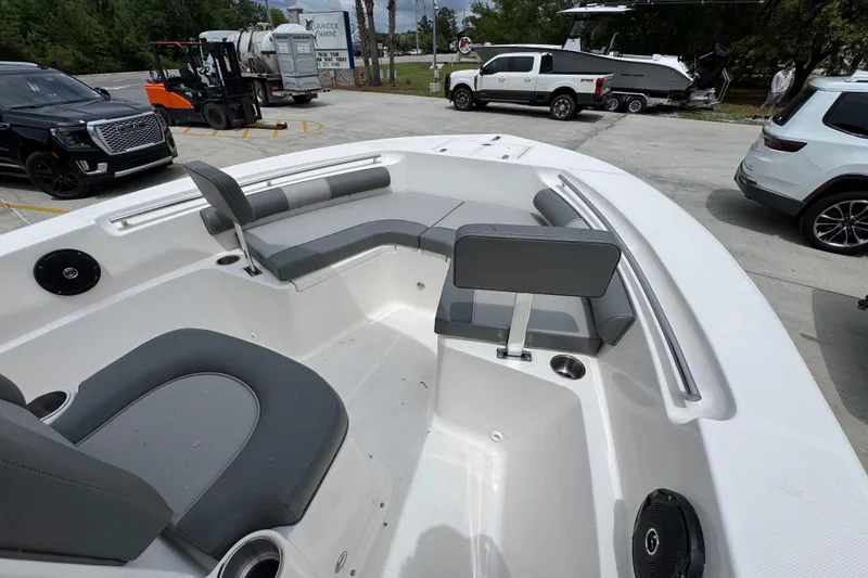 Slide: The Image of 2026 Sea Born LX21 Center Console boat interior with gray seating and cup holders. - 15