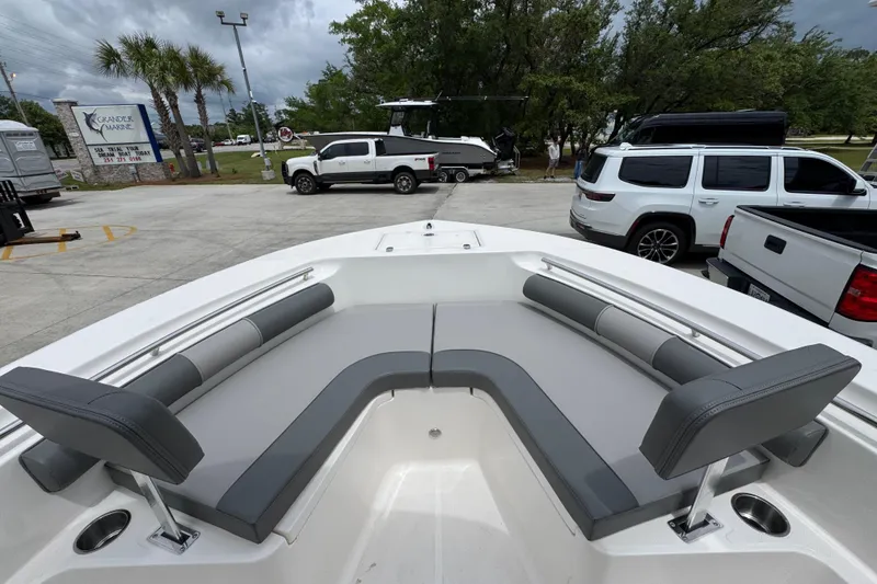 Slide: The Image of 2026 Sea Born LX21 Center Console boat with spacious seating in a marina setting. - 16
