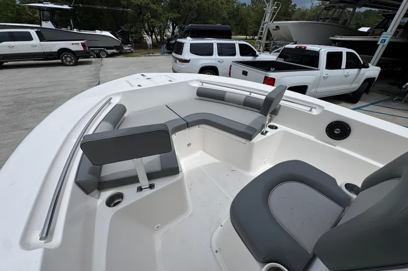 Slide: The Image of 2026 Sea Born LX21 Center Console boat interior with gray seating and cup holders. - 17