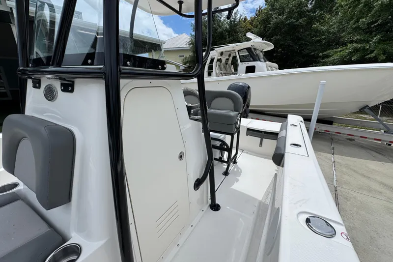 Slide: The Image of 2026 Sea Born LX21 Center Console boat, sleek design, parked outdoors. - 20