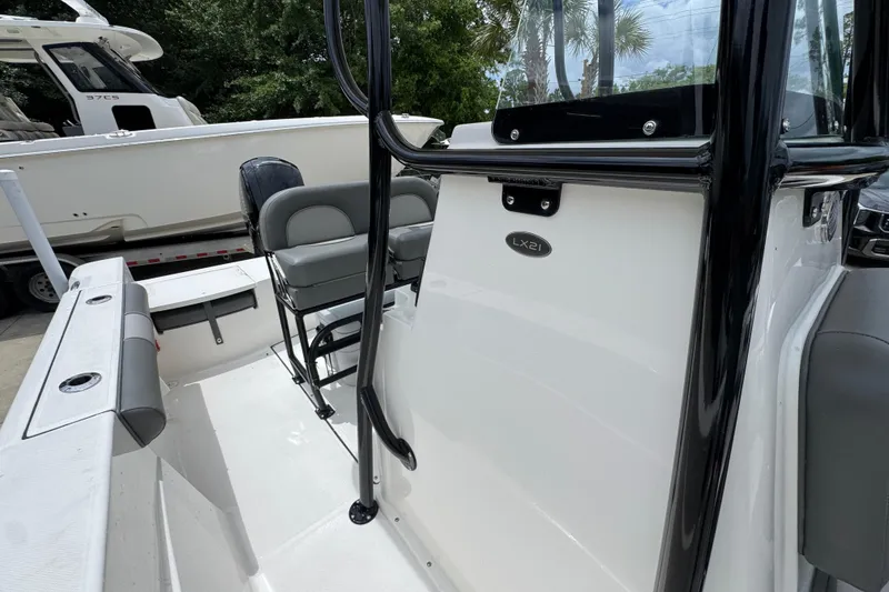Slide: The Image of 2026 Sea Born LX21 Center Console boat interior with seating and console details. - 21
