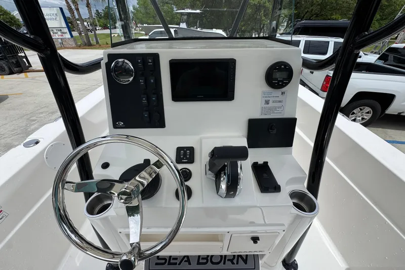 Slide: The Image of 2026 Sea Born LX21 Center Console boat dashboard with steering wheel and controls. - 26