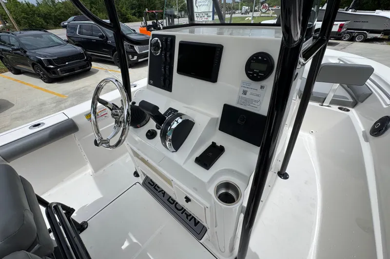 Slide: The Image of 2026 Sea Born LX21 Center Console boat interior with steering wheel and control panel. - 27
