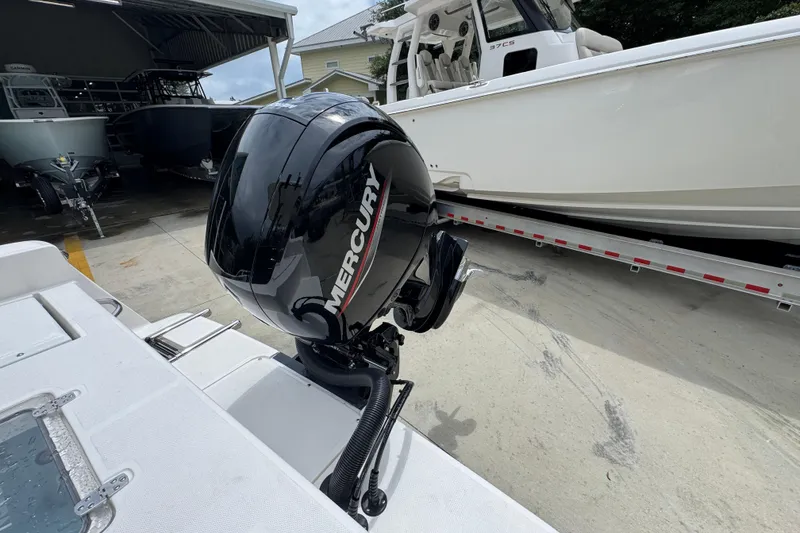 Slide: The Image of 2026 Sea Born LX21 Center Console with Mercury outboard motor in a boatyard. - 30