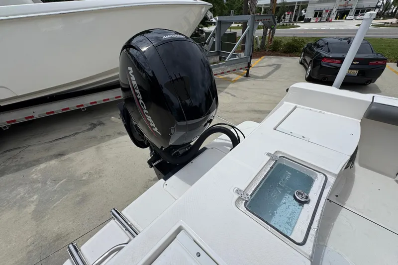Slide: The Image of 2026 Sea Born LX21 Center Console boat with Mercury outboard motor at a marina. - 31