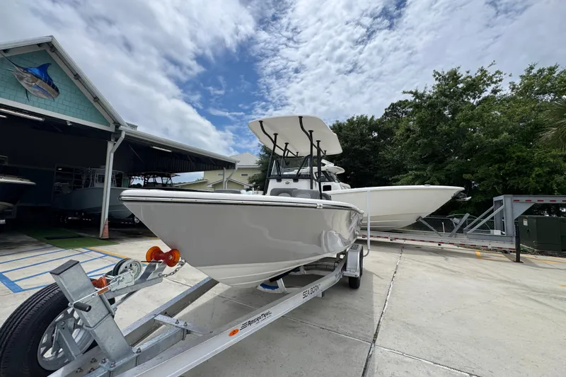 Slide: The Image of 2026 Sea Born LX21 Center Console boat on trailer, parked outdoors under cloudy sky. - 4