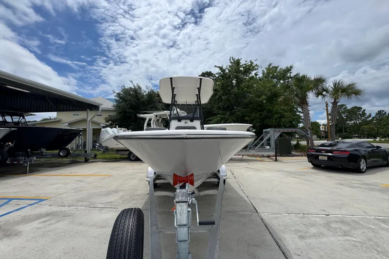Slide: The Image of 2026 Sea Born LX21 Center Console boat on trailer under cloudy sky. - 5
