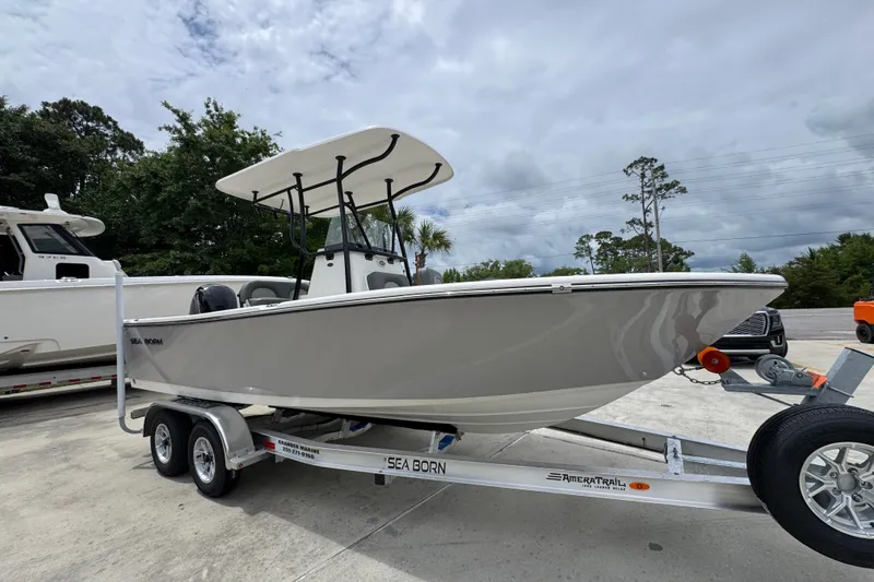 Slide: The Image of 2026 Sea Born LX21 Center Console boat on trailer, parked outdoors under cloudy sky. - 7