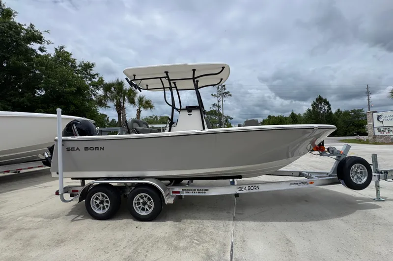 Slide: The Image of 2026 Sea Born LX21 Center Console boat on trailer, parked outdoors. - 8