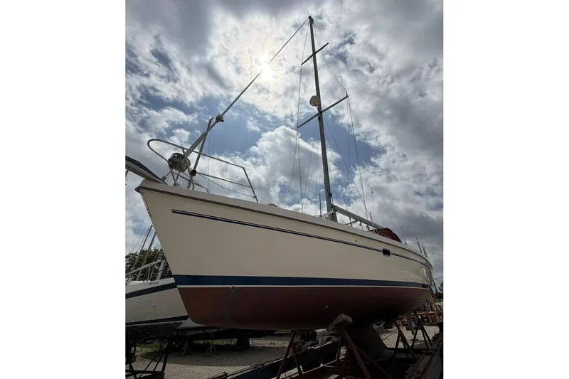 The Image of 2001 Catalina 380 sailboat on dry dock under cloudy sky. - 0