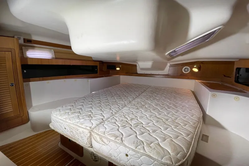 Slide: The Image of Interior cabin of a 2001 Catalina 380 sailboat with a comfortable bed. - 12