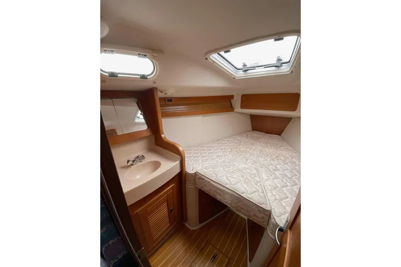 Slide: The Image of Interior cabin of a 2001 Catalina 380 sailboat with bed and sink. - 14