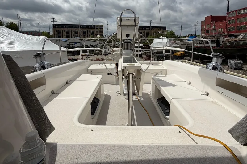 Slide: The Image of Cockpit view of a 2001 Catalina 380 sailboat, docked under cloudy skies. - 5
