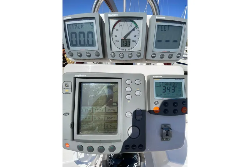 Slide: The Image of Raytheon navigation instruments on a 2001 Catalina 380 sailboat dashboard. - 6