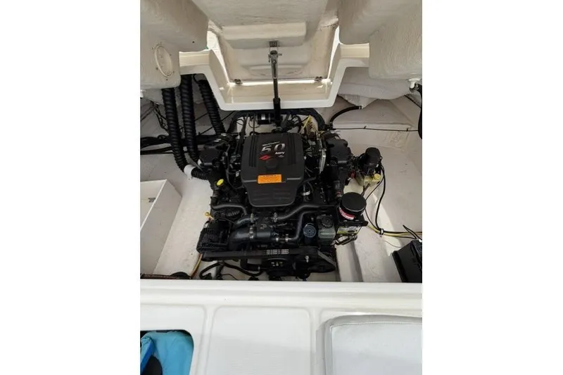 Slide: The Image of Engine compartment of a 2007 Chaparral 236 SSi boat, showcasing the engine and wiring. - 11