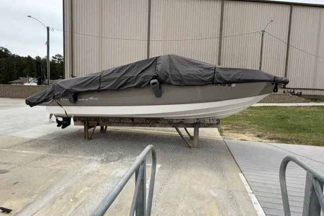 Slide: The Image of 2007 Chaparral 236 SSi boat covered and stored outdoors on a stand. - 12