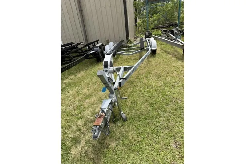 Slide: The Image of Boat trailer for 2007 Chaparral 236 SSi on grassy area near a building. - 13