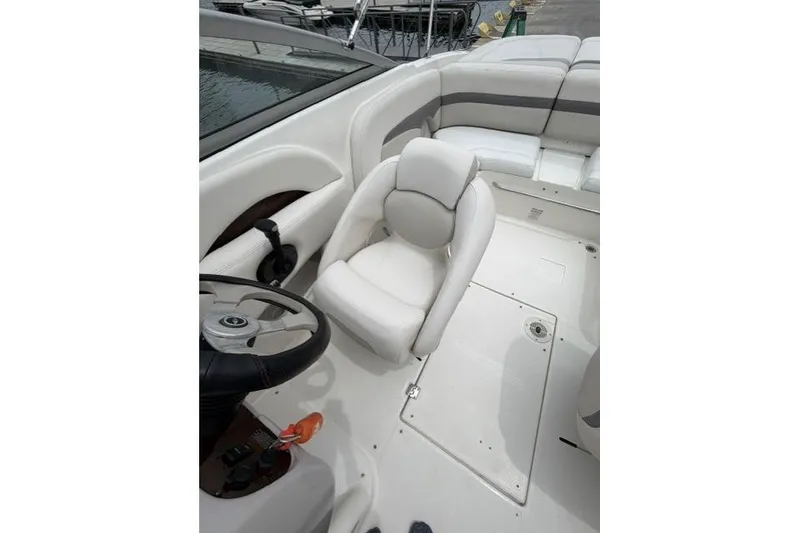 Slide: The Image of 2007 Chaparral 236 SSi boat interior with white seating and steering wheel. - 6