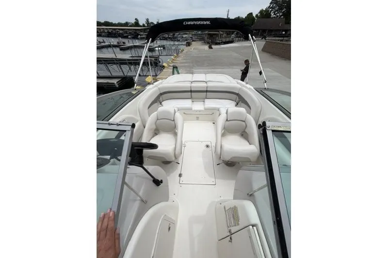 Slide: The Image of 2007 Chaparral 236 SSi boat interior with white seating at a marina. - 8