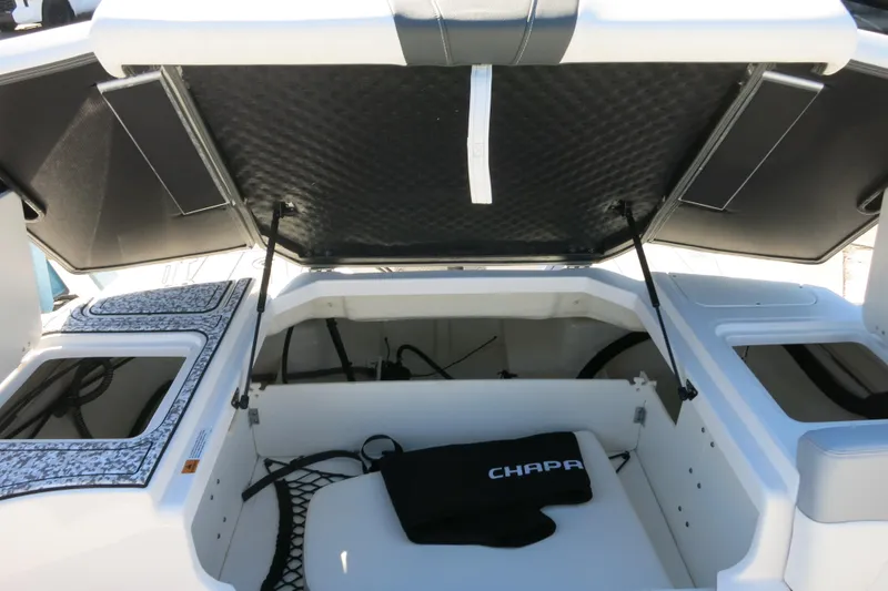 Slide: The Image of 2024 Chaparral 23 SSi OB boat storage compartment with open hatch and interior view. - 10