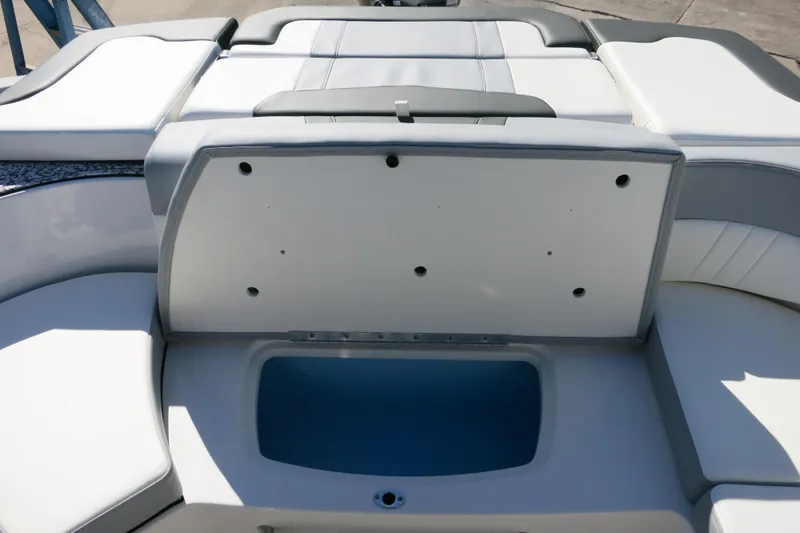 Slide: The Image of 2024 Chaparral 23 SSi OB boat interior with open storage compartment. - 11