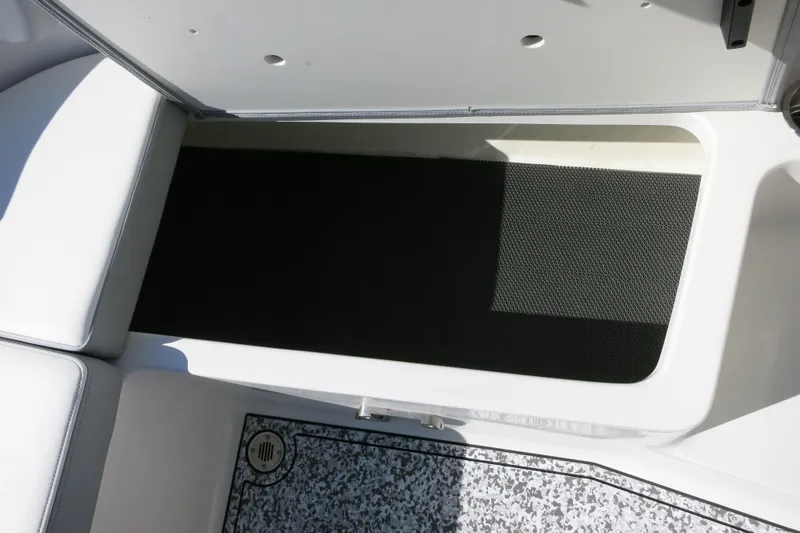 Slide: The Image of Interior view of 2024 Chaparral 23 SSi OB boat, featuring seating and flooring details. - 13