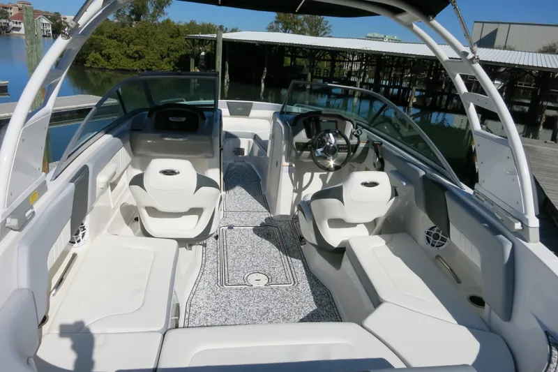 Slide: The Image of 2024 Chaparral 23 SSi OB boat interior with sleek seating and modern dashboard design. - 15
