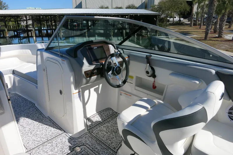 Slide: The Image of 2024 Chaparral 23 SSi OB boat interior with modern dashboard and comfortable seating. - 17