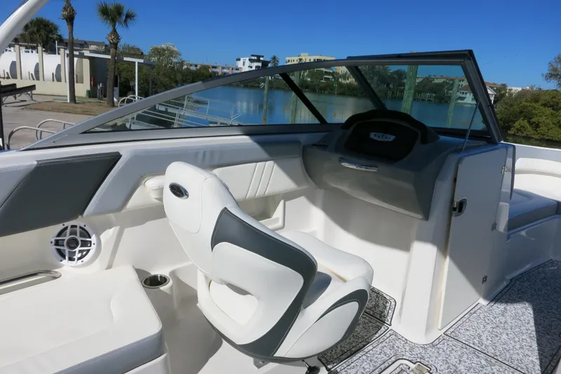 Slide: The Image of 2024 Chaparral 23 SSi OB boat interior with sleek seating and modern dashboard design. - 18