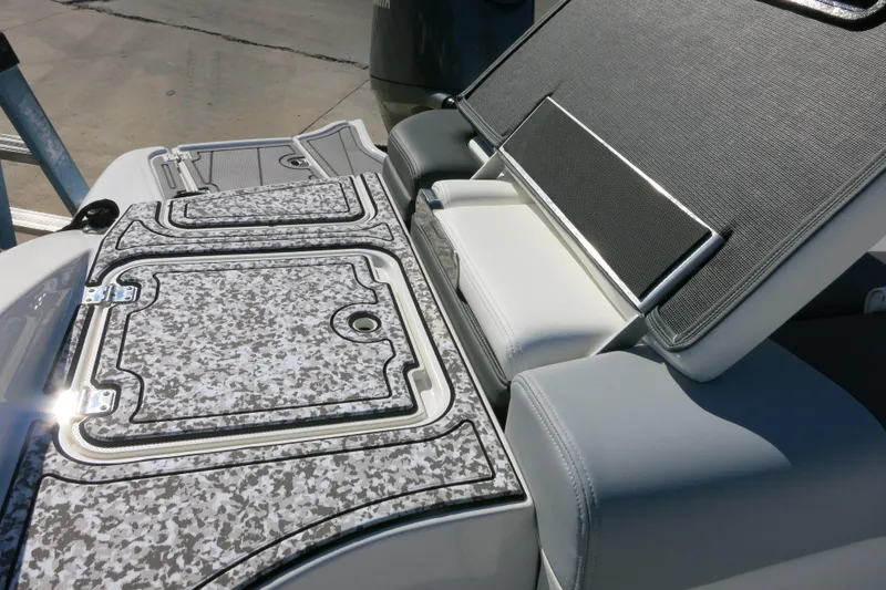 Slide: The Image of 2024 Chaparral 23 SSi OB boat interior with textured seating and storage compartments. - 20