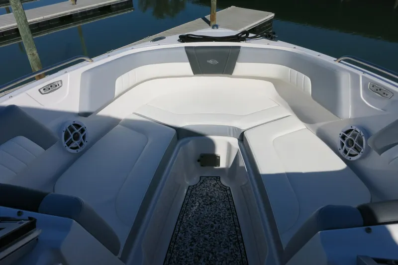 Slide: The Image of 2024 Chaparral 23 SSi OB boat interior with white seating and speakers. - 21