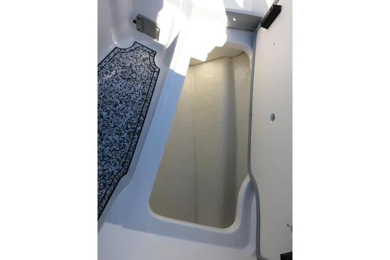 Slide: The Image of 2024 Chaparral 23 SSi OB boat storage compartment with textured flooring detail. - 23