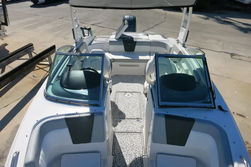 Slide: The Image of 2024 Chaparral 23 SSi OB boat interior with open windshield and seating area. - 27