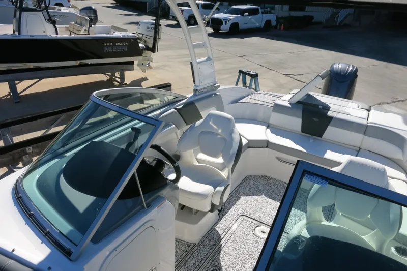 Slide: The Image of 2024 Chaparral 23 SSi OB boat interior with sleek seating and modern dashboard design. - 29