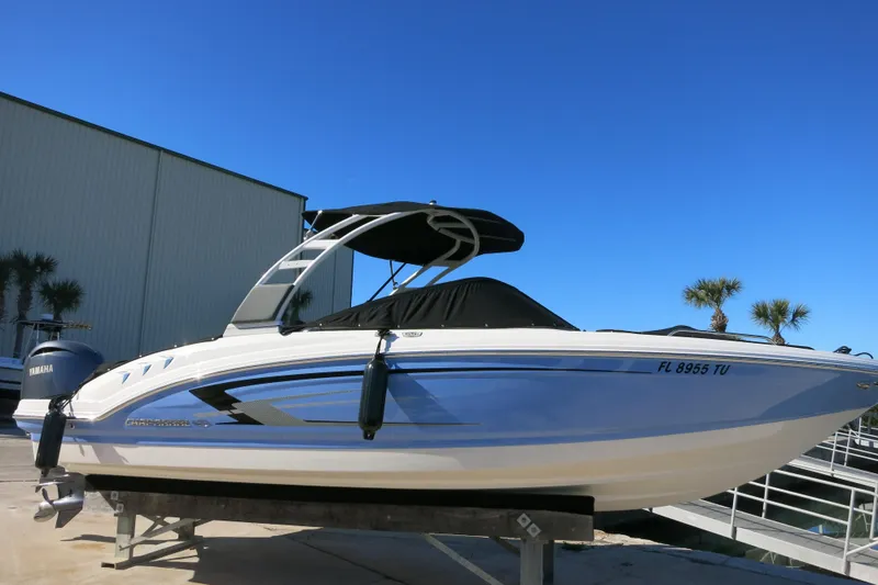 Slide: The Image of 2024 Chaparral 23 SSi OB boat with Yamaha engine, docked under clear blue sky. - 3