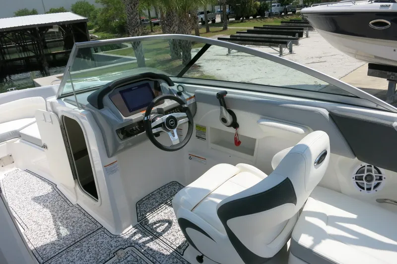 Slide: The Image of 2024 Chaparral 23 SSi OB boat interior with steering wheel and seating. - 39