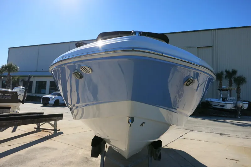Slide: The Image of 2024 Chaparral 23 SSi OB boat displayed outdoors, showcasing sleek design and modern features. - 4