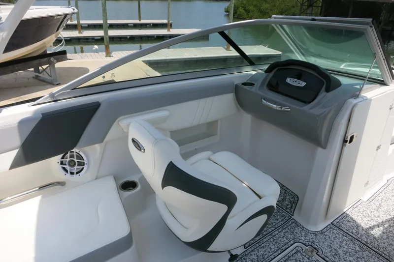 Slide: The Image of 2024 Chaparral 23 SSi OB boat interior with helm, seating, and speaker. - 40