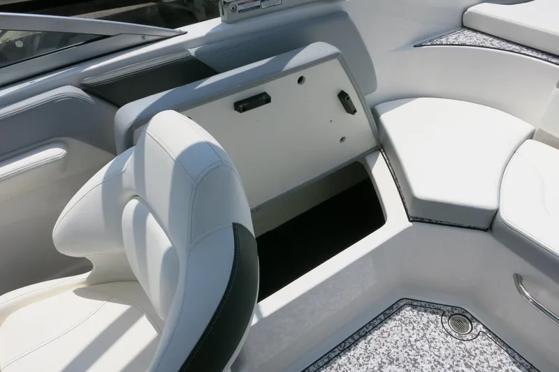 Slide: The Image of 2024 Chaparral 23 SSi OB boat interior with open storage compartment and seating. - 51
