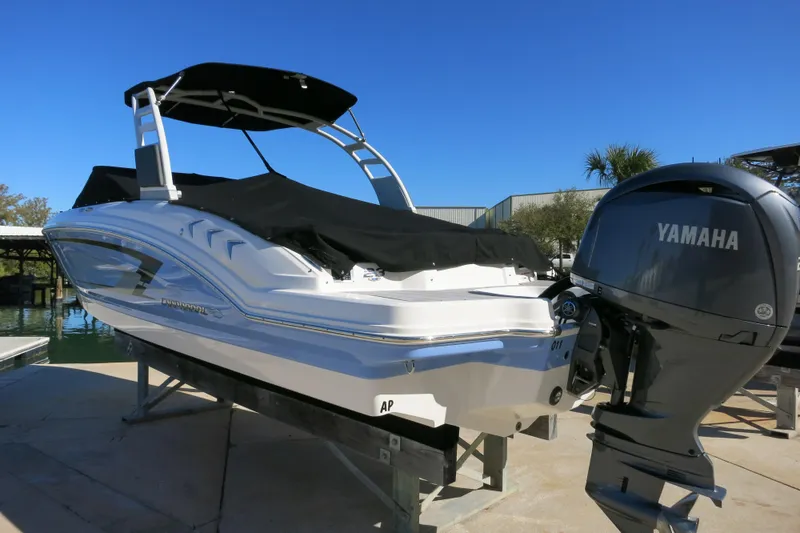 Slide: The Image of 2024 Chaparral 23 SSi OB boat with Yamaha outboard engine, docked under clear blue sky. - 6