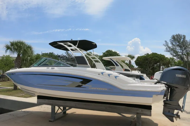 Slide: The Image of 2024 Chaparral 23 SSi OB boat with Yamaha outboard, displayed outdoors on a sunny day. - 61