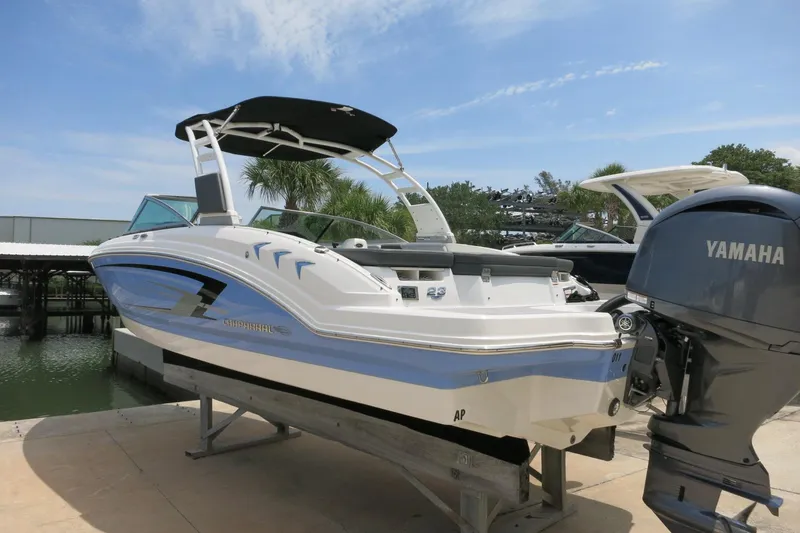 Slide: The Image of 2024 Chaparral 23 SSi OB boat with Yamaha outboard motor, docked under a clear sky. - 62