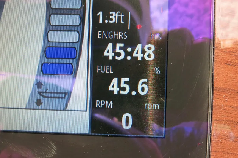 Slide: The Image of Boat dashboard display showing engine hours, fuel percentage, and RPM for 2024 Chaparral 23 SSi OB. - 65