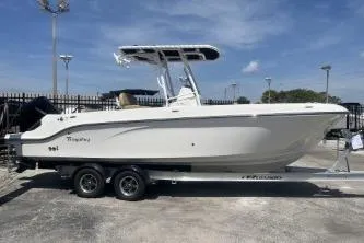 The Image of 2023 Trophy T24 CC boat on trailer, parked outdoors under blue sky. - 1