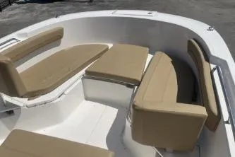 Slide: The Image of 2023 Trophy T24 CC boat interior with beige cushioned seating. - 10