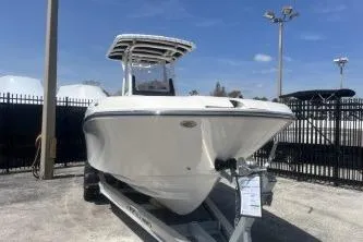 Slide: The Image of 2023 Trophy T24 CC boat on trailer, displayed outdoors under clear sky. - 3