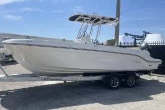 Slide: The Image of 2023 Trophy T24 CC boat on trailer, parked outdoors under clear sky. - 5