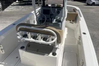 Slide: The Image of 2023 Trophy T24 CC boat interior with steering console and rod holders. - 8
